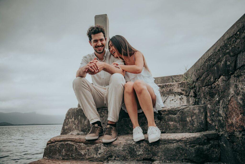 Couple sitting on steps near water