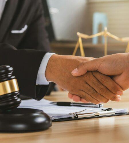 justice and law concept.Legal law, advice and justice, Businessman handshake with a lawyer.