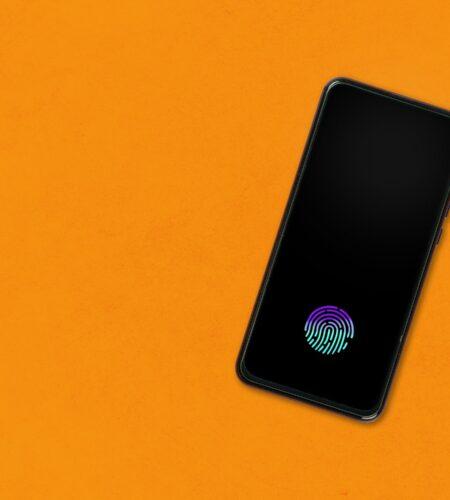 Smartphone with fingerprint on orange background