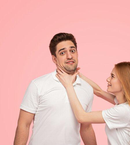 Angry young woman strangling man