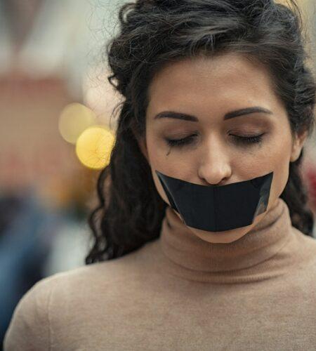 Woman fighting against harassment with closed eyes